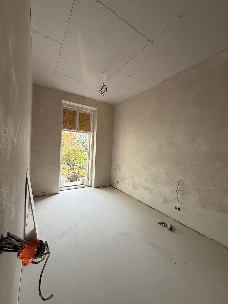Dokončený pokoj s novými omítkami na stěnách i stropě, připravený pod malbu.